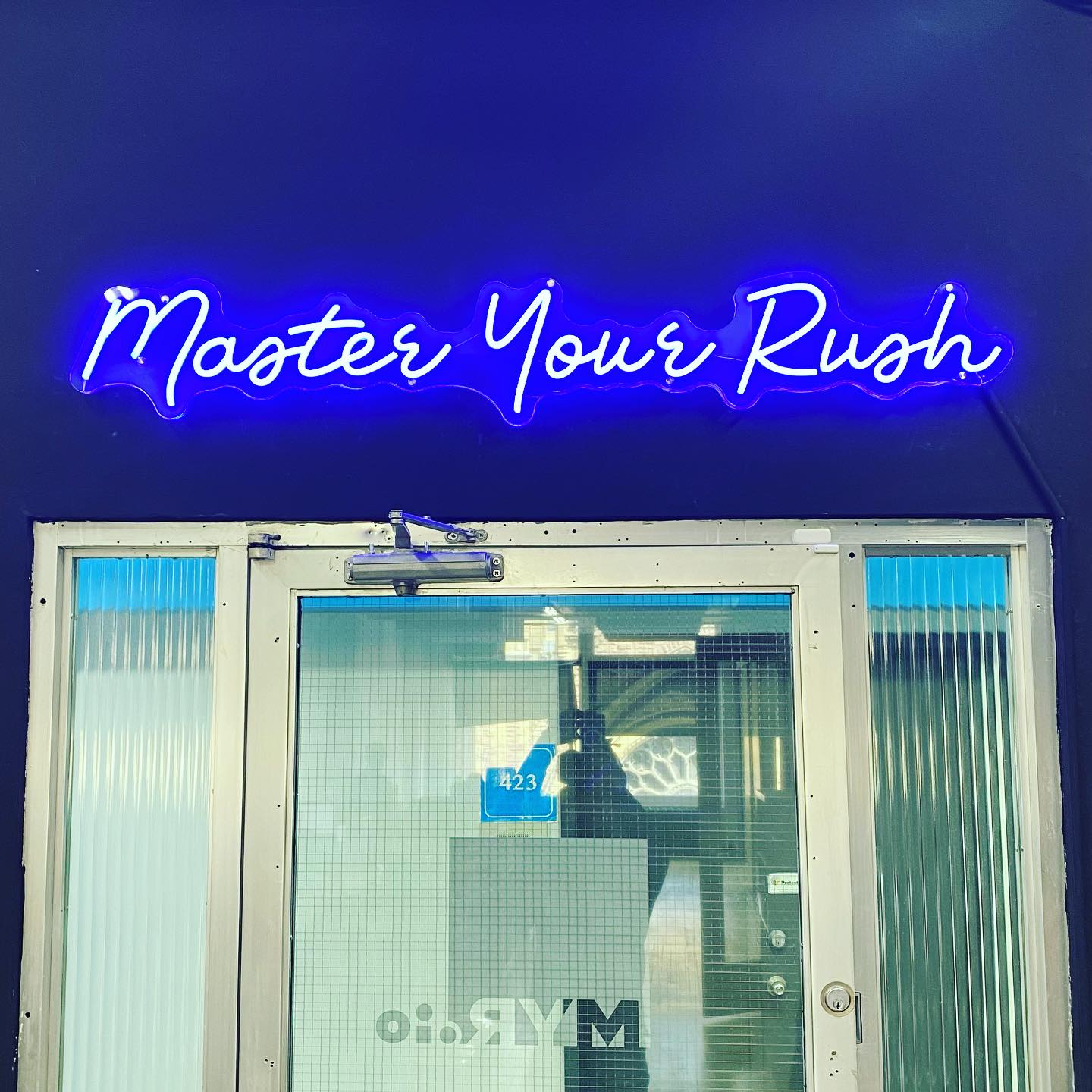 blue neon sign that says &quot;master your rush&quot;