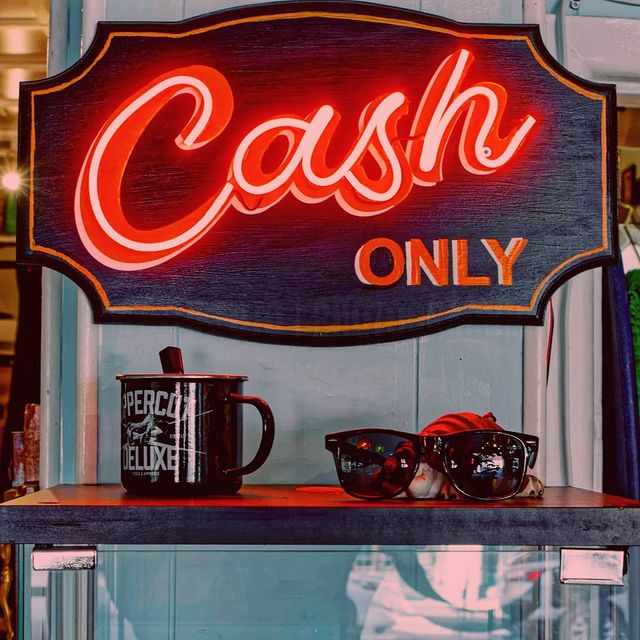 red neon sign that says cash only